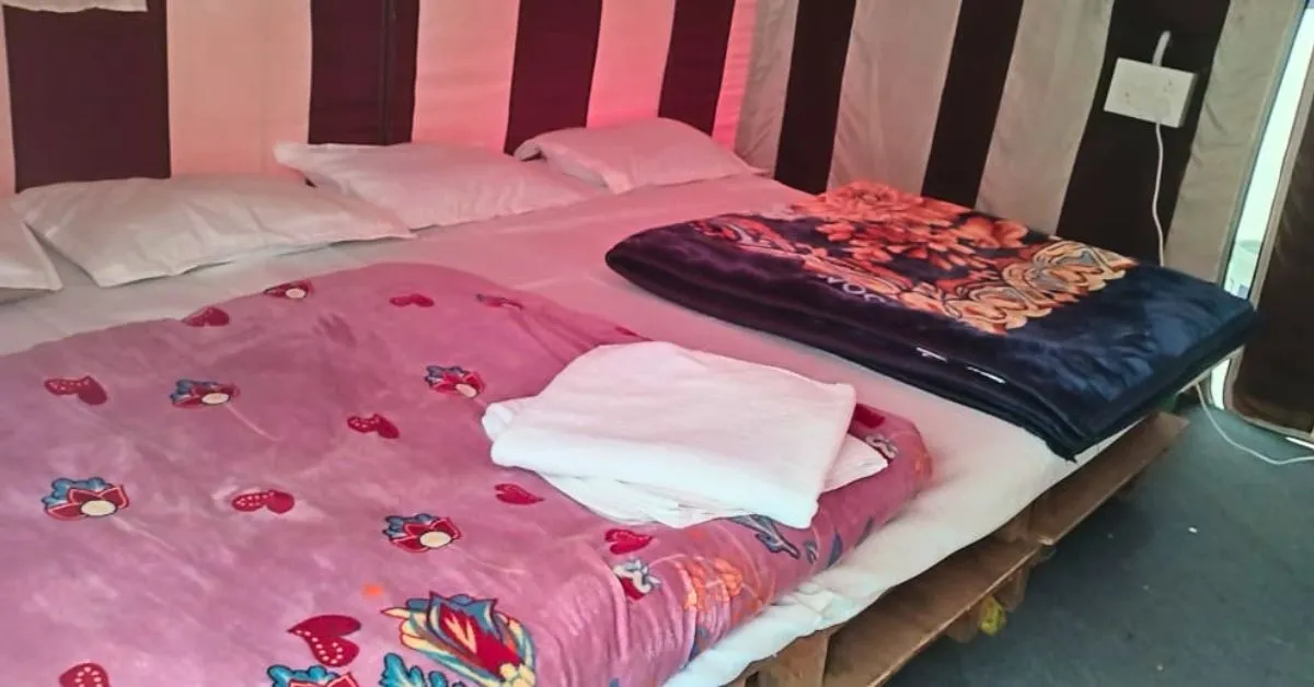 Adventure tent interior with comfortable beds at Valencia River Resort