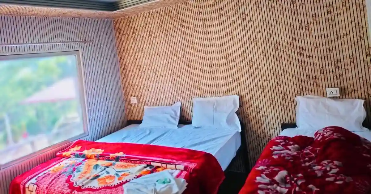 Deluxe AC cottage interior with bamboo walls and twin beds at Valencia Resort